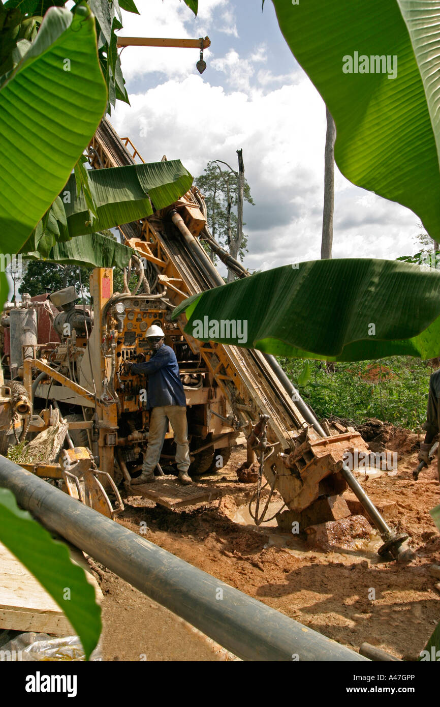 Exploration core drilling, showing driller with rig in bush, surface
