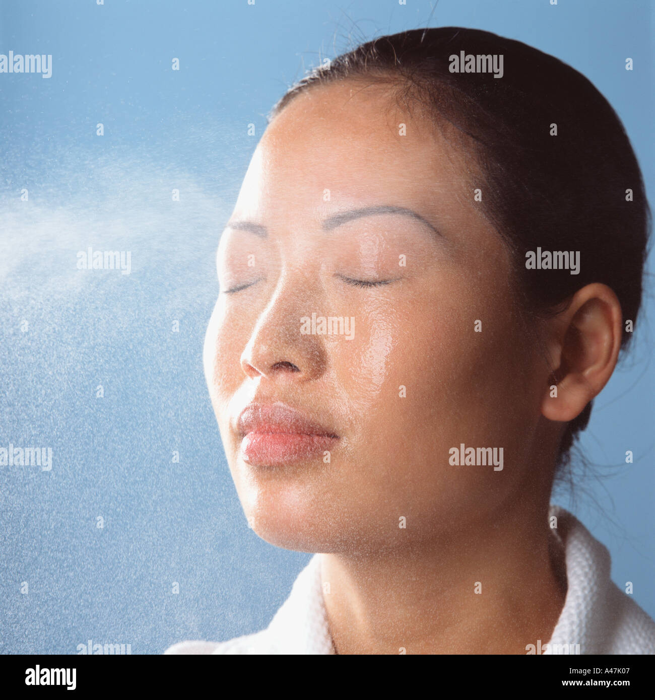 Water spraying on womans face Stock Photo
