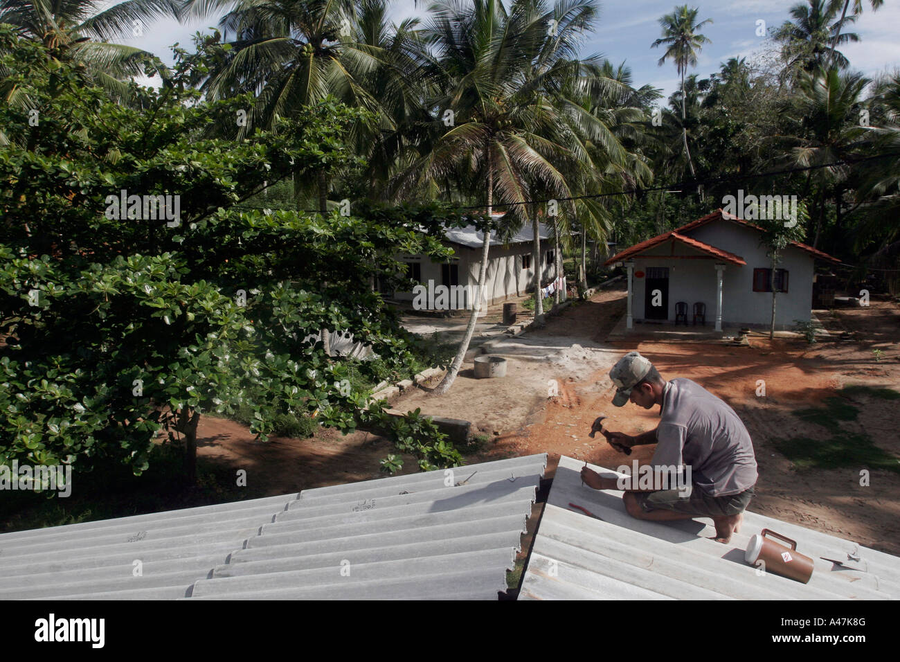 A construction worker builds a new house for one of the many families ...