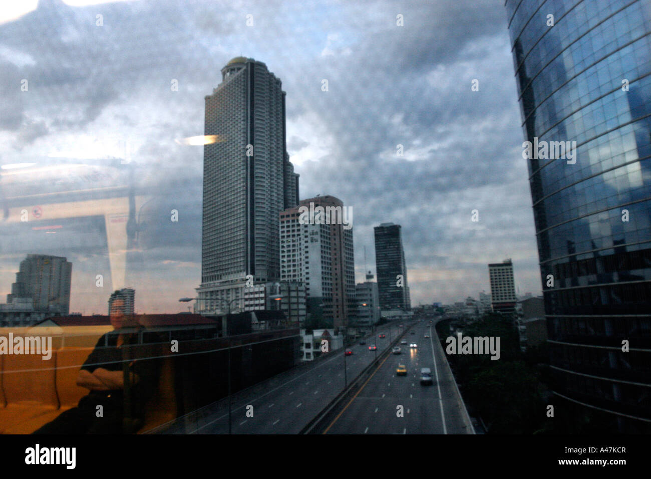 Modern high rise buildings seen from the window of a local train in Bangkok in Thailand Stock Photo