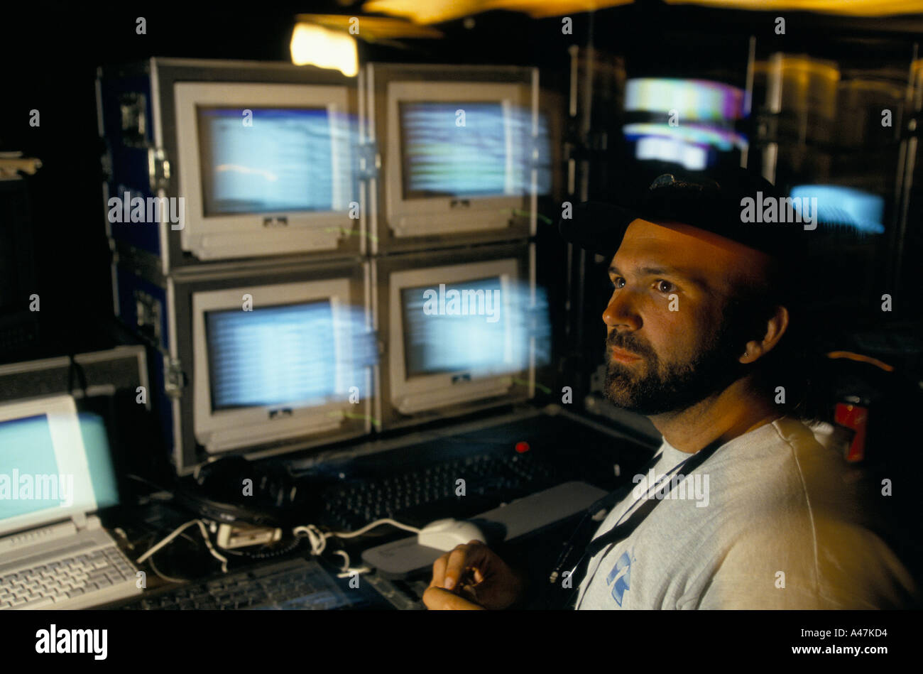 U2 on tour June 1993 pop group U2 on tour technician with bank of tv monitors and  computer screens Stock Photo
