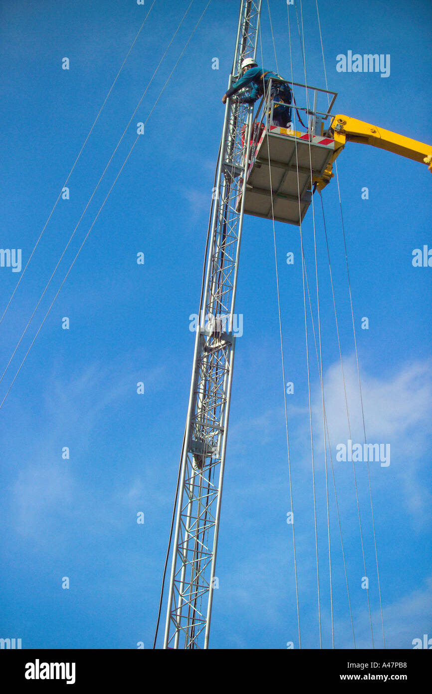 Man on crane working on mast Stock Photo Alamy