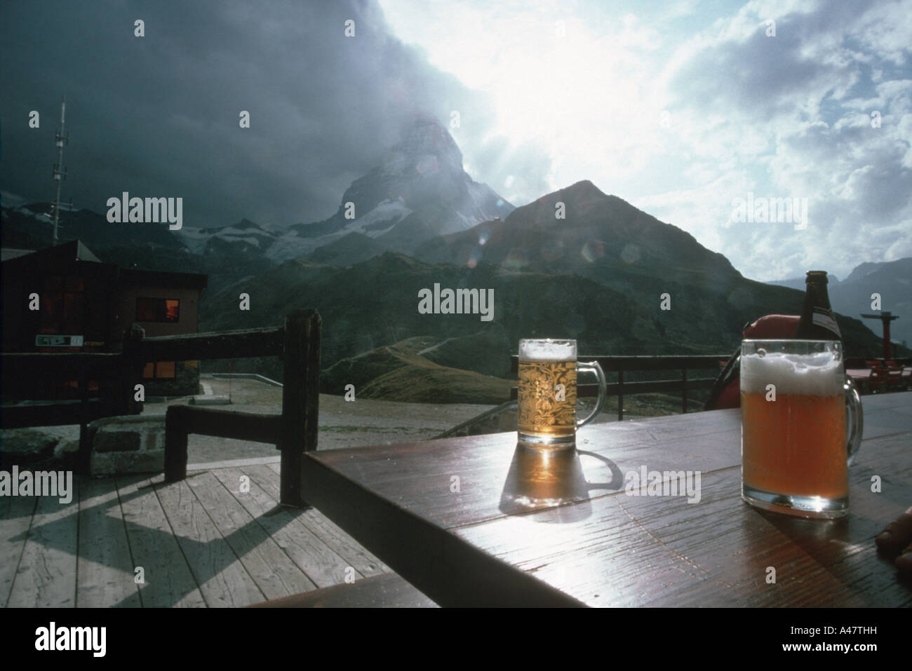 Two pints of beer on a table with the Matterhorn behind Stock Photo