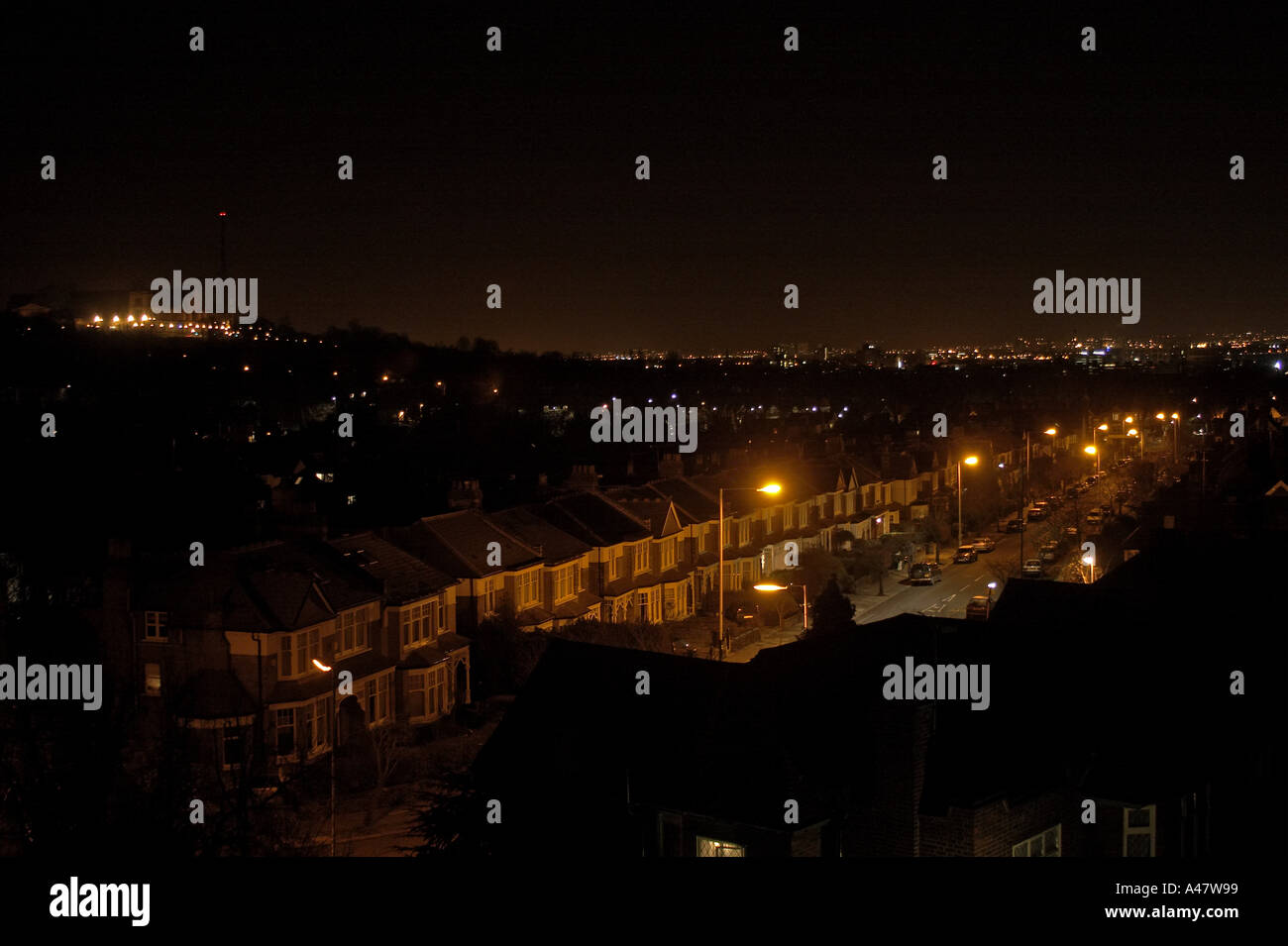 Nightime view of street in Muswell Hill North London N10 showing effect of light pollution and wasted power and electricity ener Stock Photo