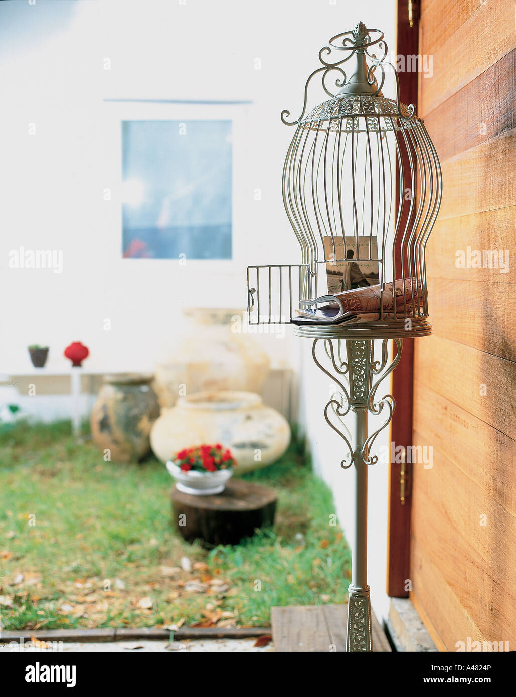 Closeup of a magazine with a newspaper and a photograph in a birdcage