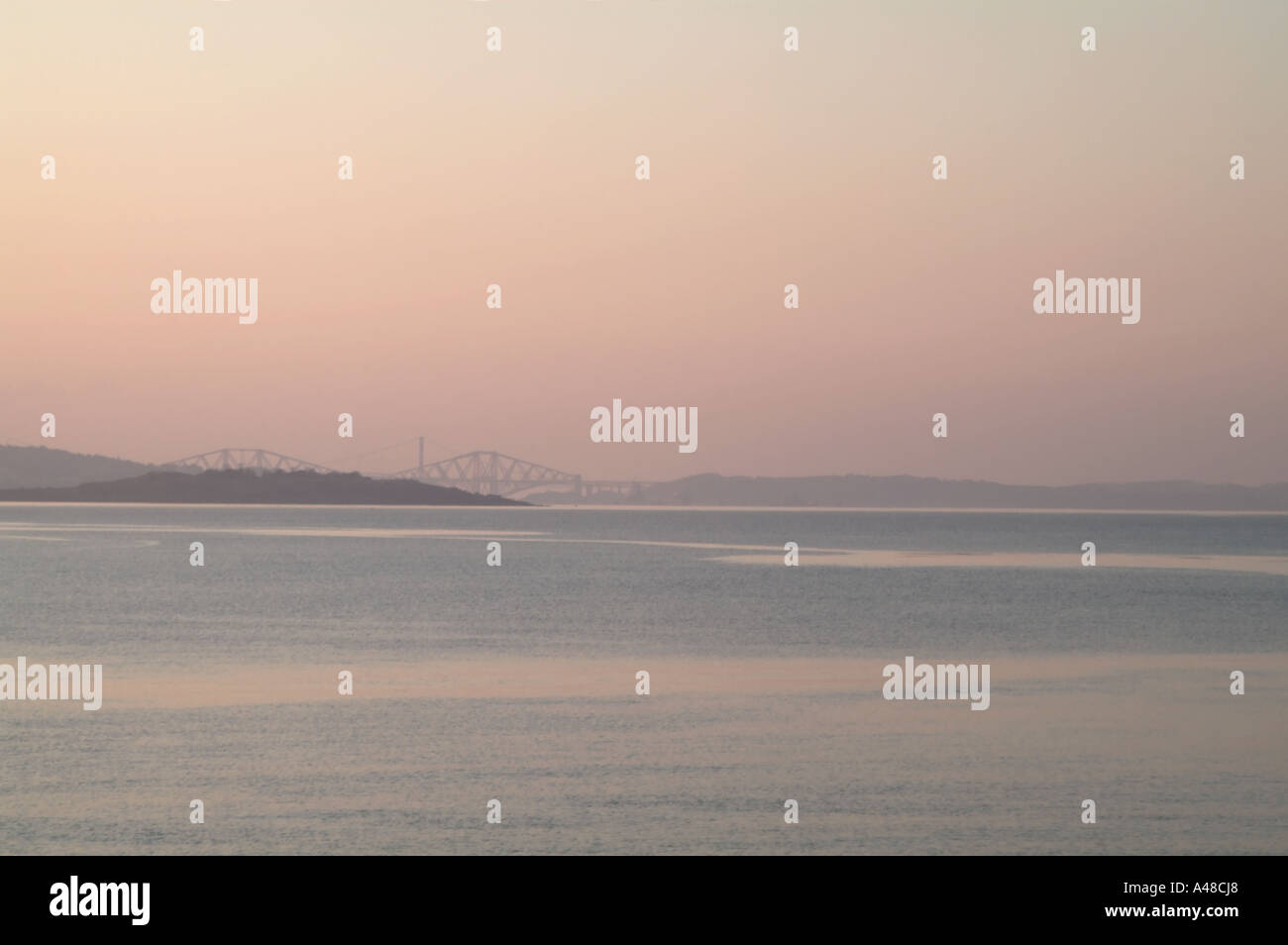 View West across the Firth of Forth during a cold misty sunset Stock Photo