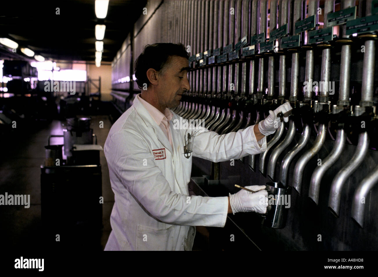 A  man drawing off concentrated essential oils for mixing into fragrances and perfume Stock Photo