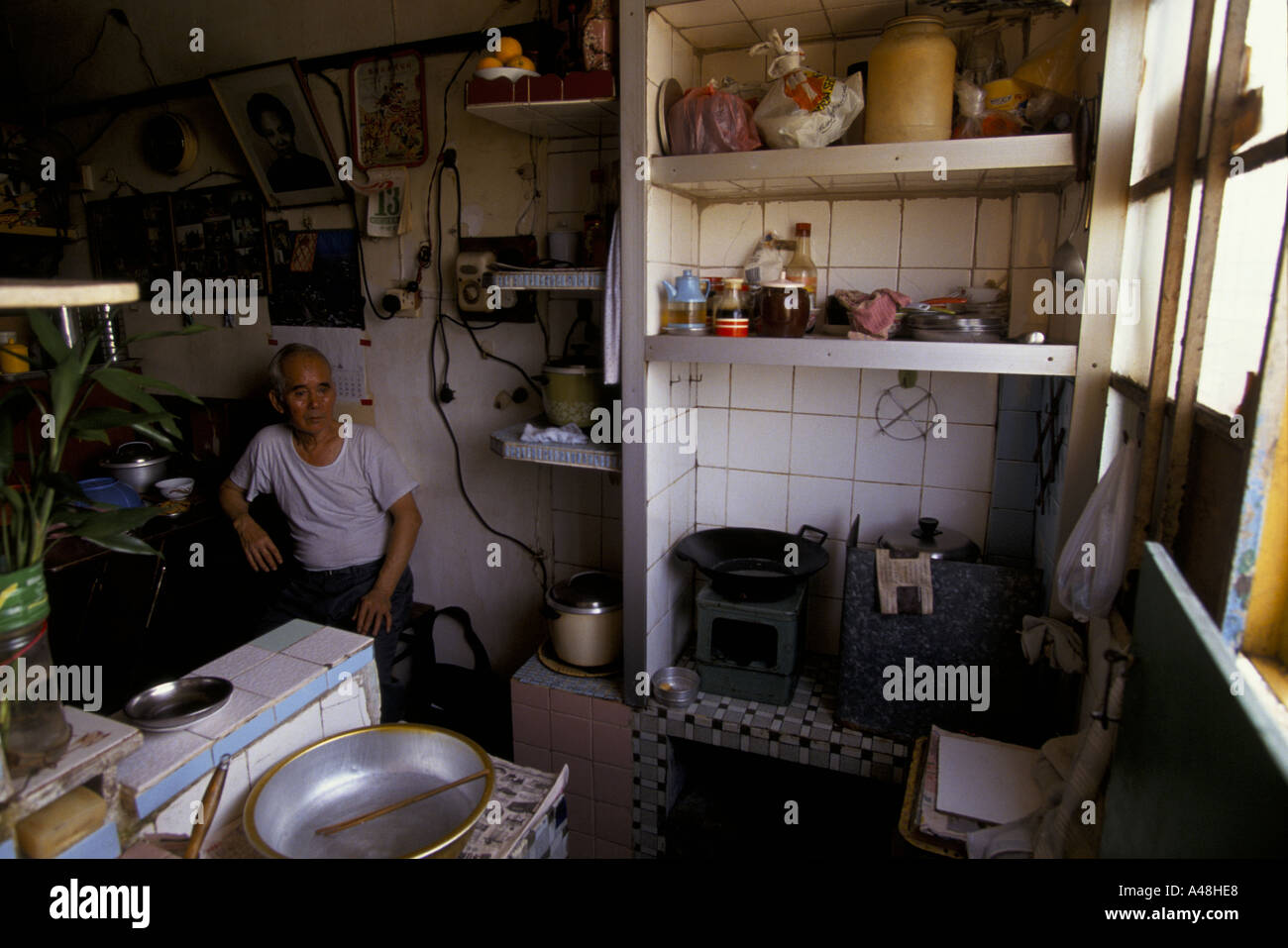 Man In Kitchen Of His Tvery Small Flat In Kowloon Hong Kong Stock Photo Alamy