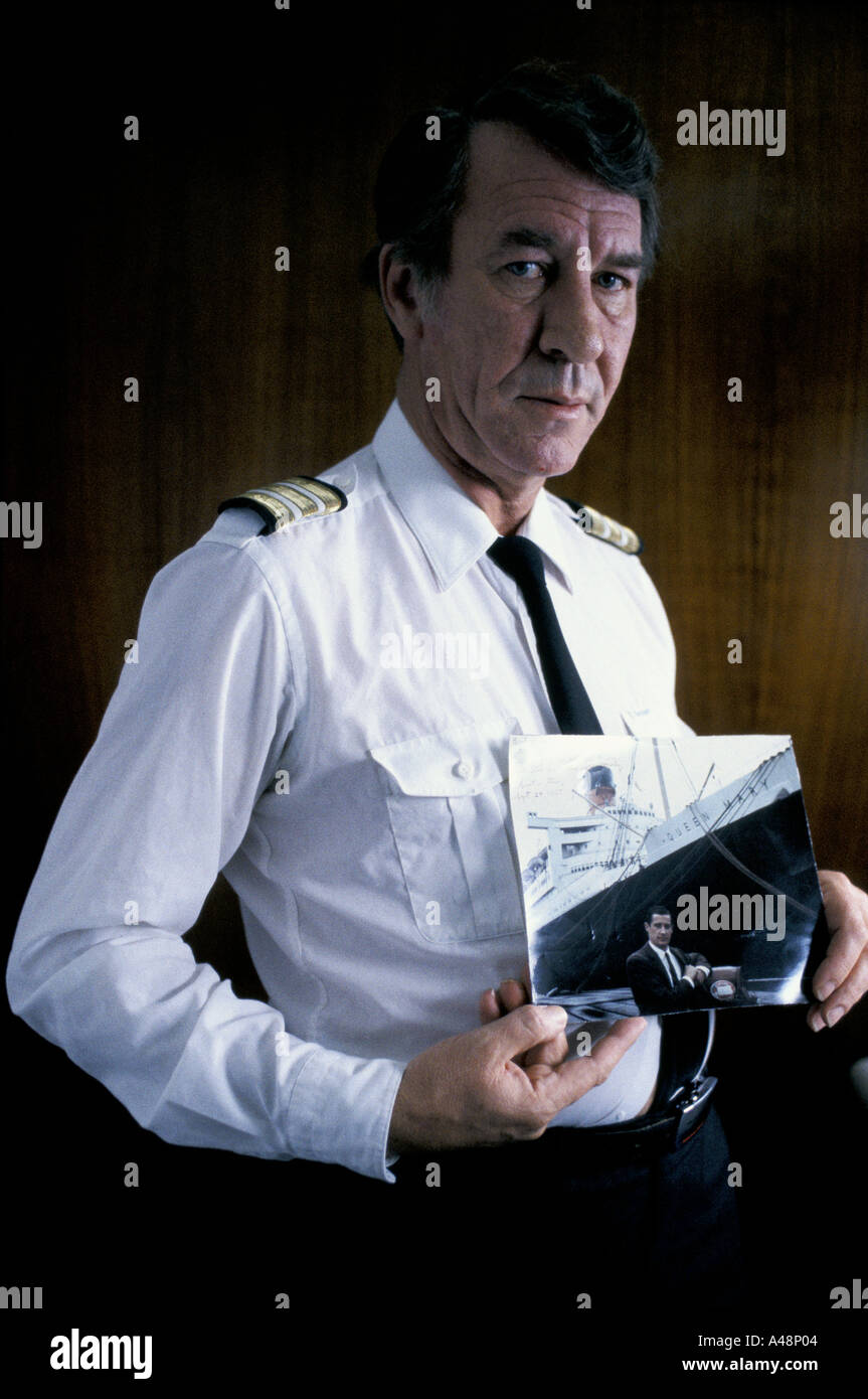 The Purser On Qe2 Holding A Photo Of The Cruise Ship Queen Mary On Which He Stowed Away As A Boy Stock Photo Alamy