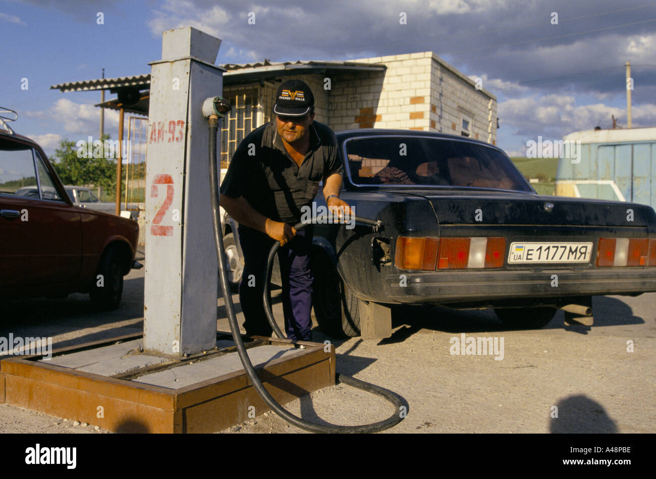 Man filling his car with petrol at a garage .Crimea Ukraine Stock Photo