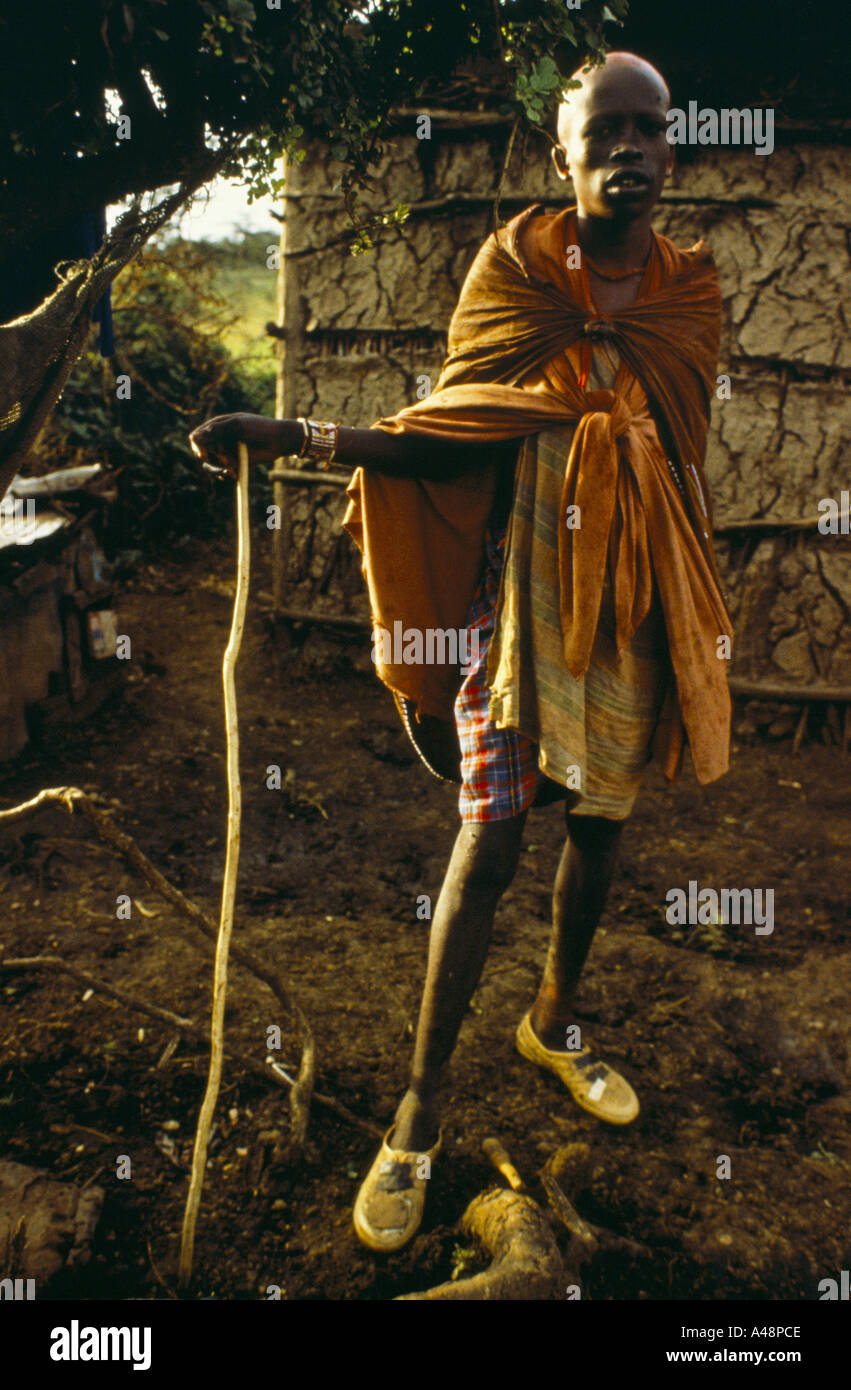 A teenage masai warrior outside a mud hut. Ngong Hills Kenya Stock Photo