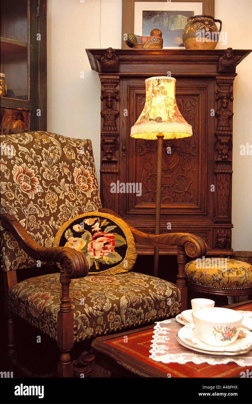 Floor lamp beside an armchair in a room Stock Photo - Alamy