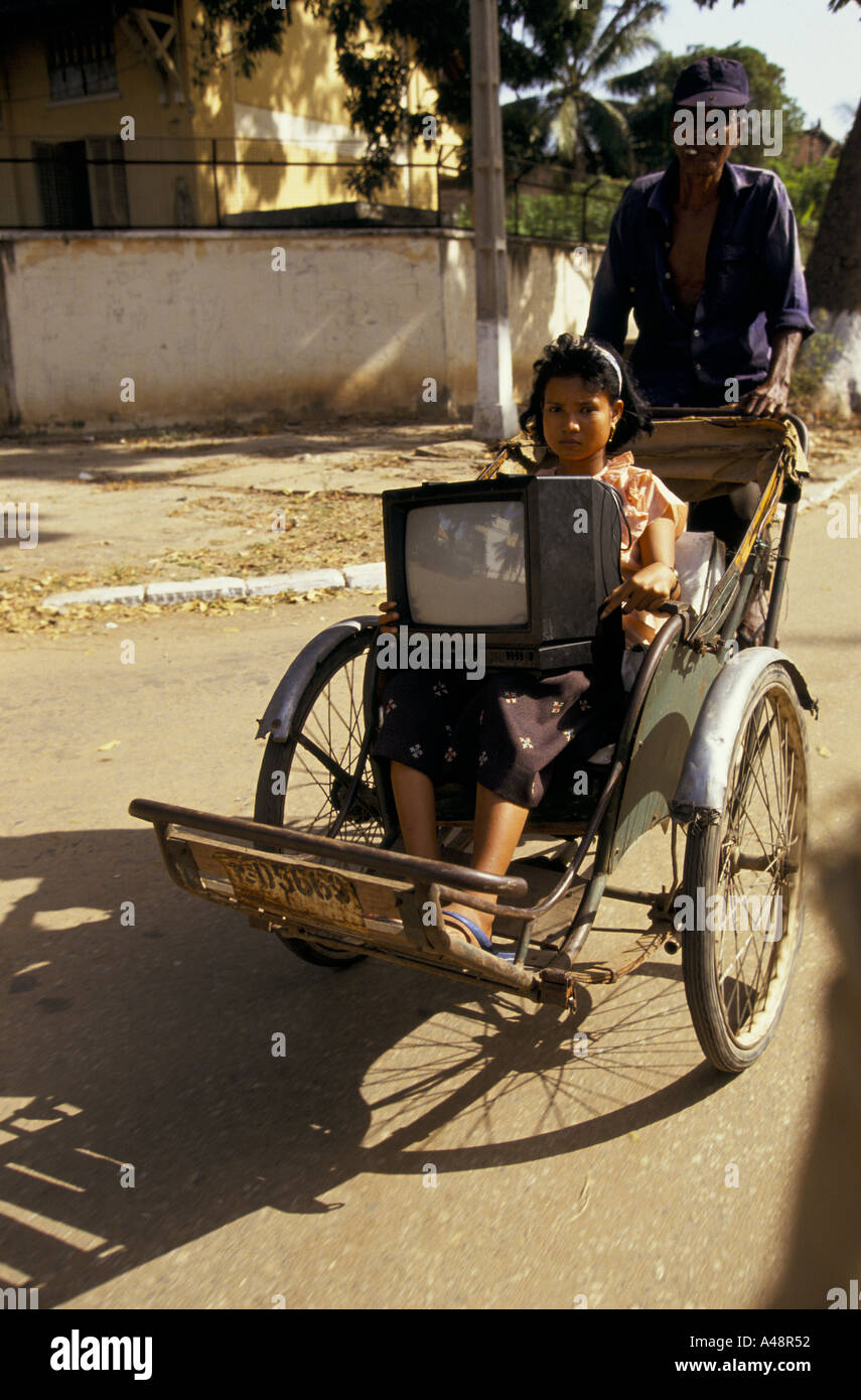 cambodia pnhom penh a woman taking a television home on a rickshaw Stock Photo