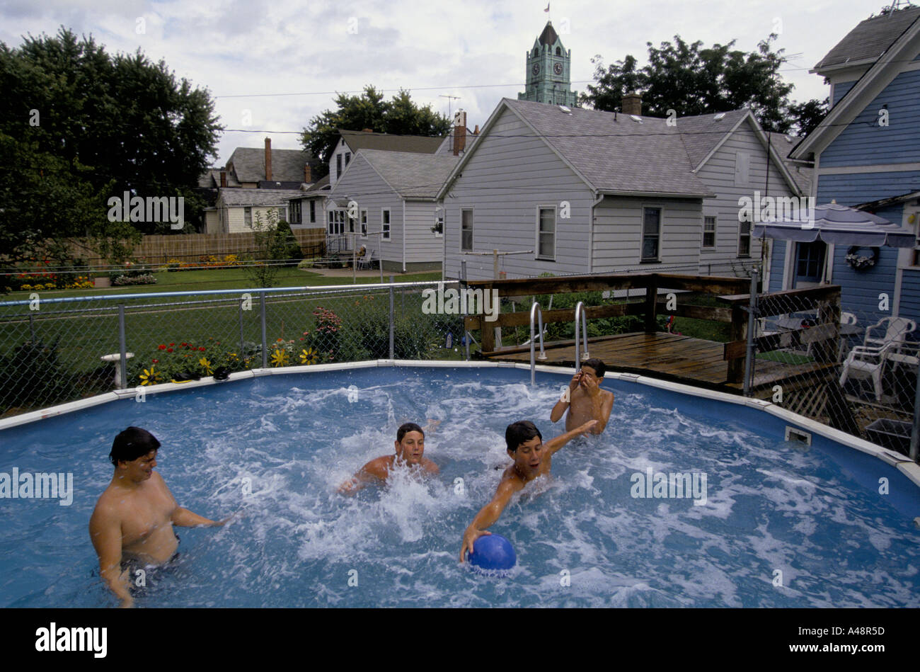 Lincoln Highway boys play in back garden bathing pool during summer
