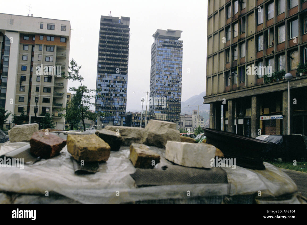 sarajevo july 1994 two high rise tower block buildings with windows shot out amongst war damaged buildings Stock Photo