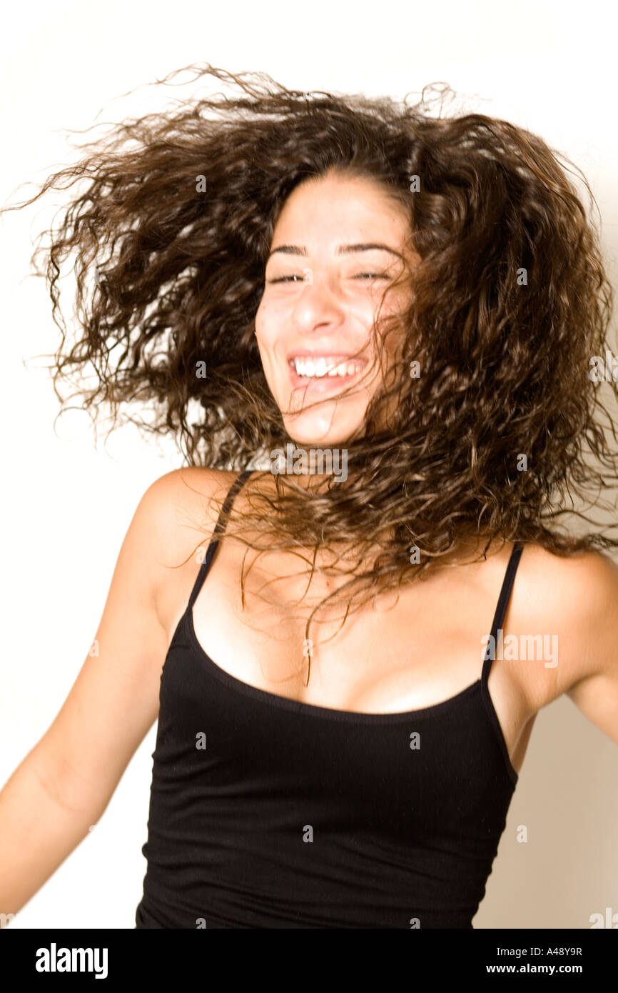 Young woman enjoying by white background Stock Photo