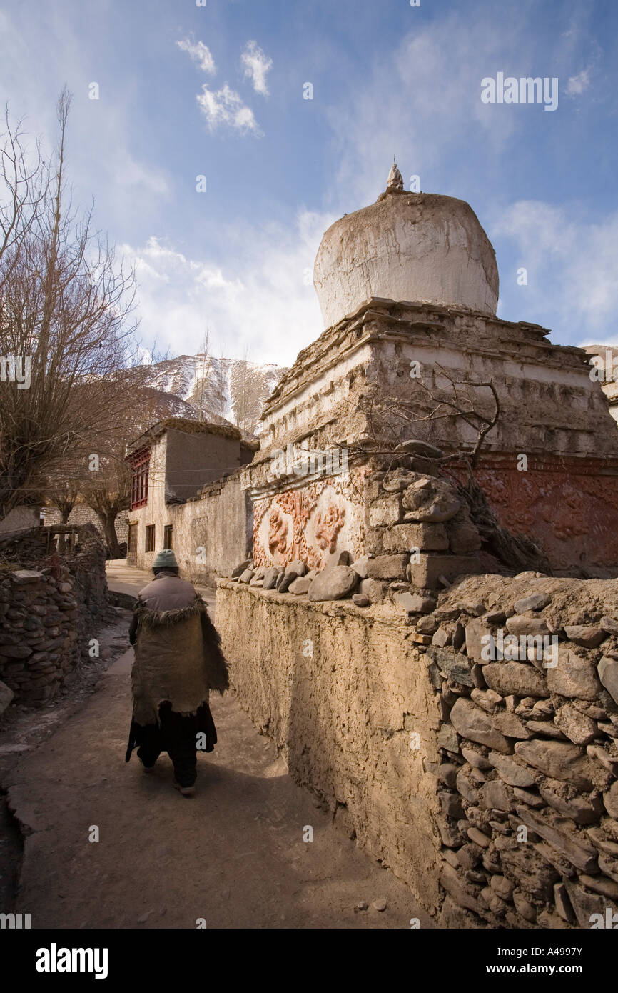 India Ladakh Leh Valley Alchi village woman walking past old votive stupa Stock Photo
