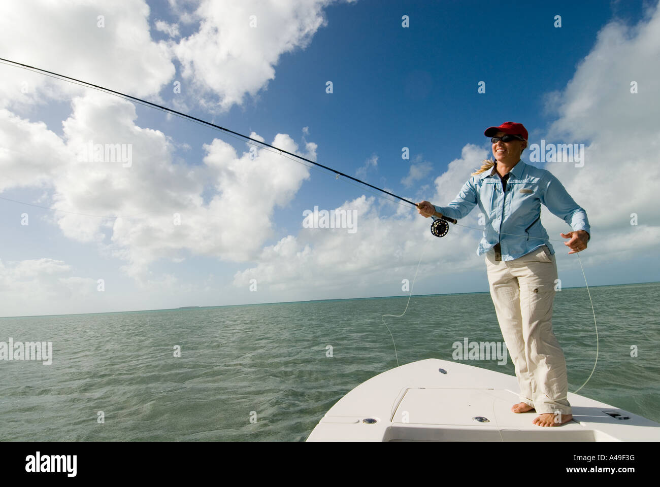 USA Florida Keys Woman fisherman in red hat fly fishing from boat in salt  water flats Stock Photo - Alamy