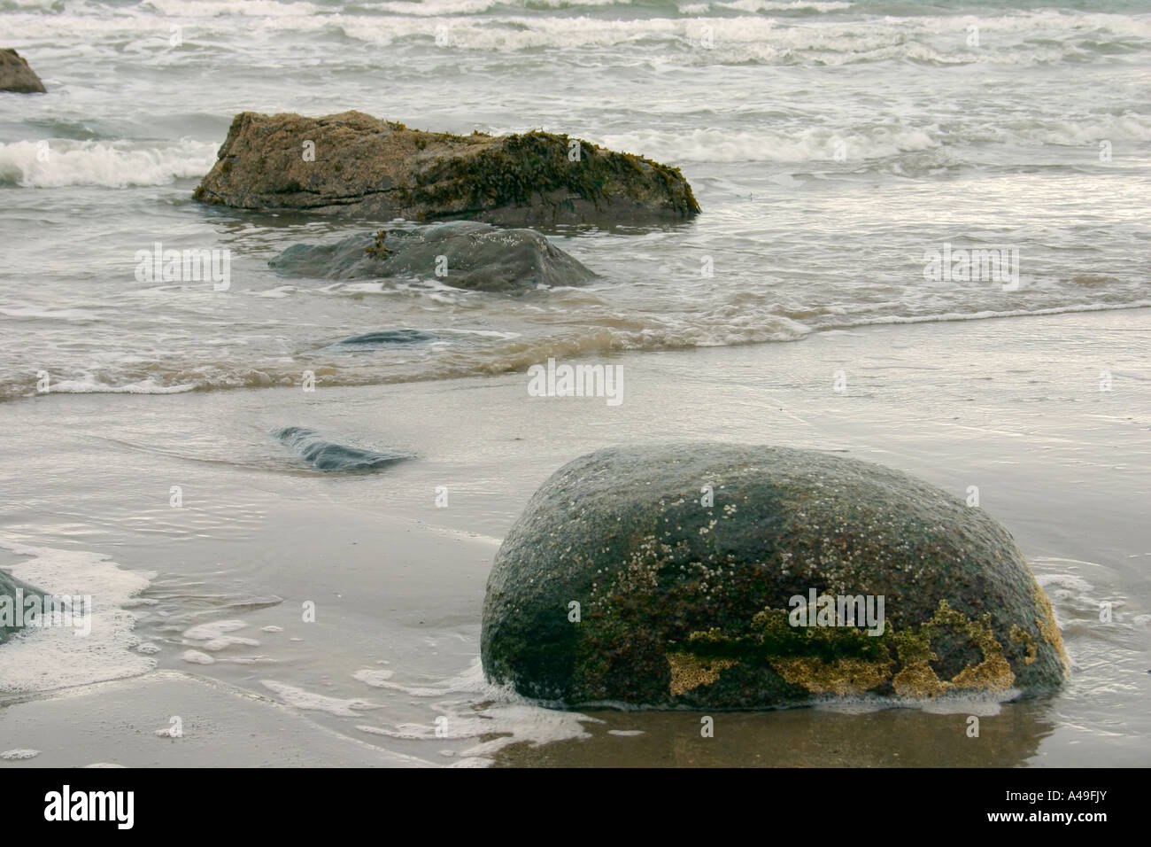 Rocks sand and sea at seaside Stock Photo - Alamy