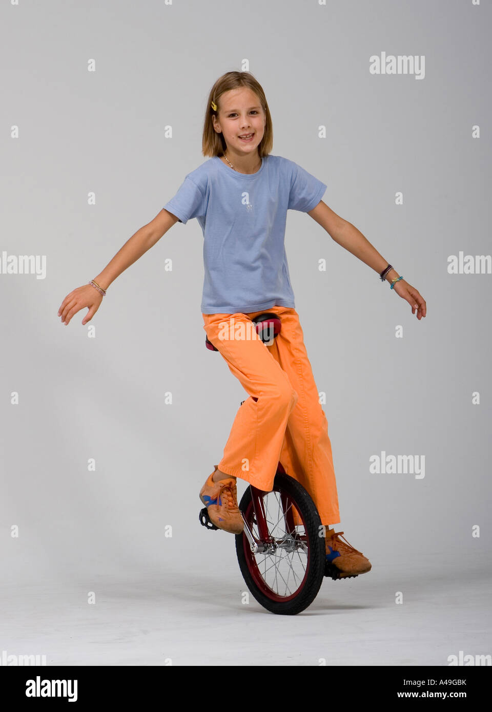 Girl riding a unicycle Stock Photo Alamy