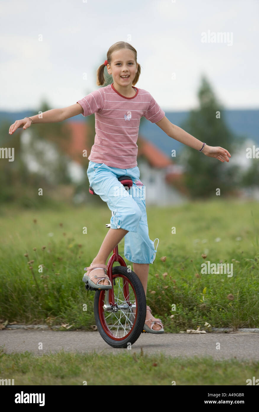 Girl riding a unicycle Stock Photo Alamy