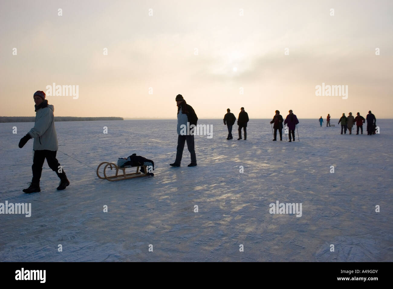 Tourists on the frozen Feder Lake, Bad Buchau, Germany Stock Photo