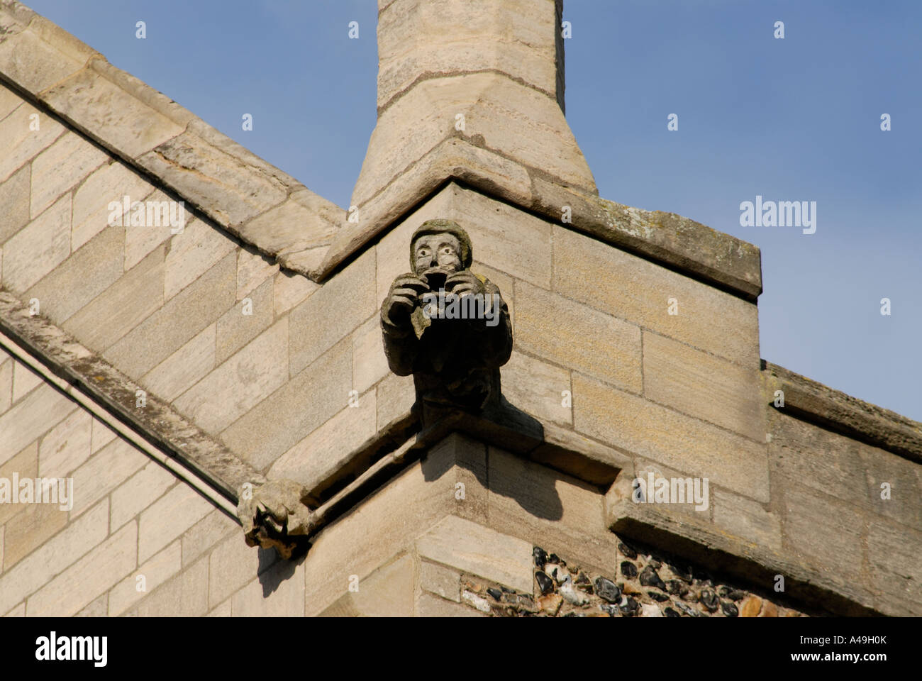 Gargoyle in the form a priest pulling a face on The brand new tower of the new gothic revival Bury St Edmunds Cathedral Stock Photo