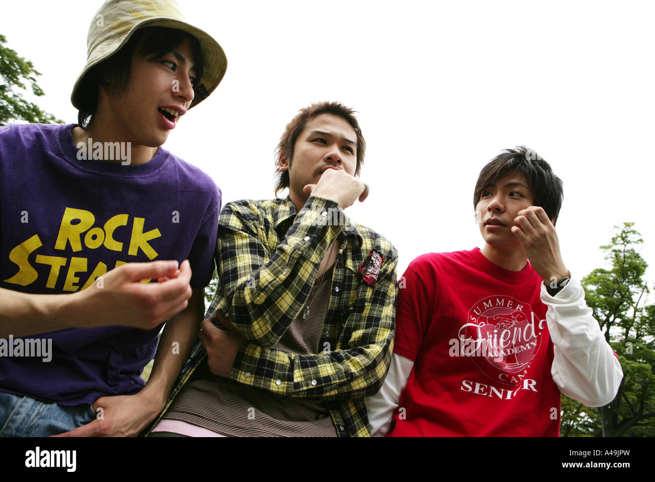 Low angle view of three young men Stock Photo - Alamy