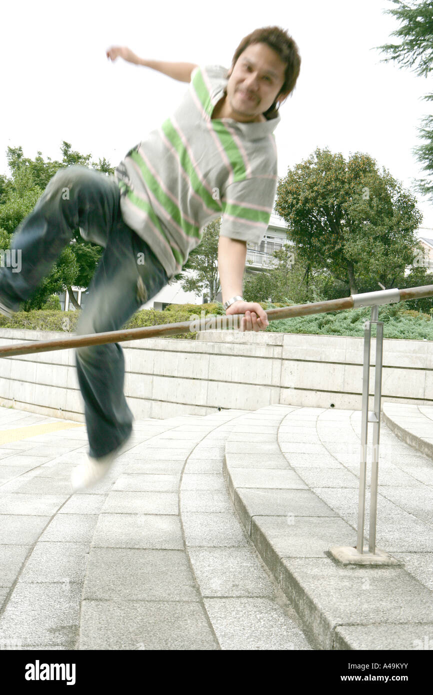 Young man jumping over railing hires stock photography and images Alamy