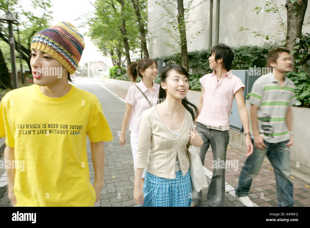 Two young women and three young men walking together Stock Photo - Alamy
