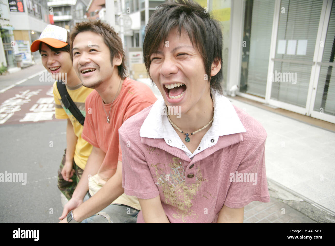 Three young men smiling Stock Photo - Alamy