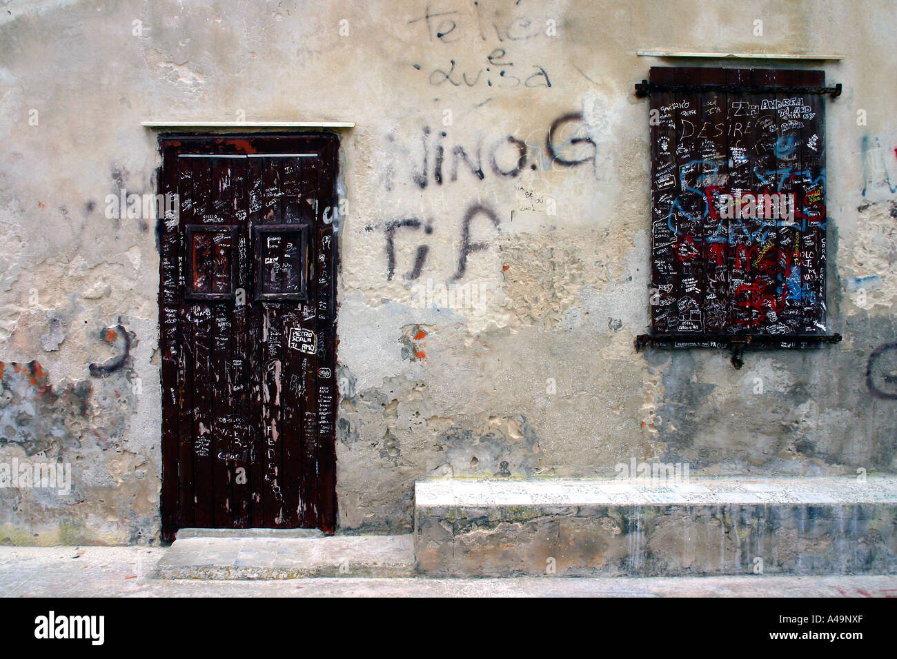 Doorway and window of a graffiti covered house in the tuna fishing town