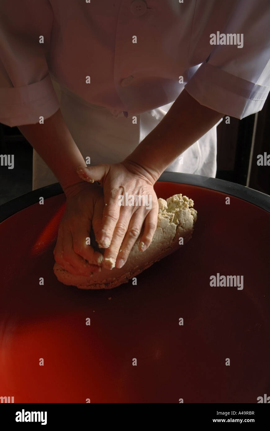 Mid section view of a chef kneading dough Stock Photo