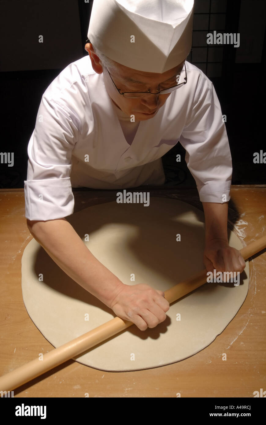 High angle view of a chef rolling dough Stock Photo