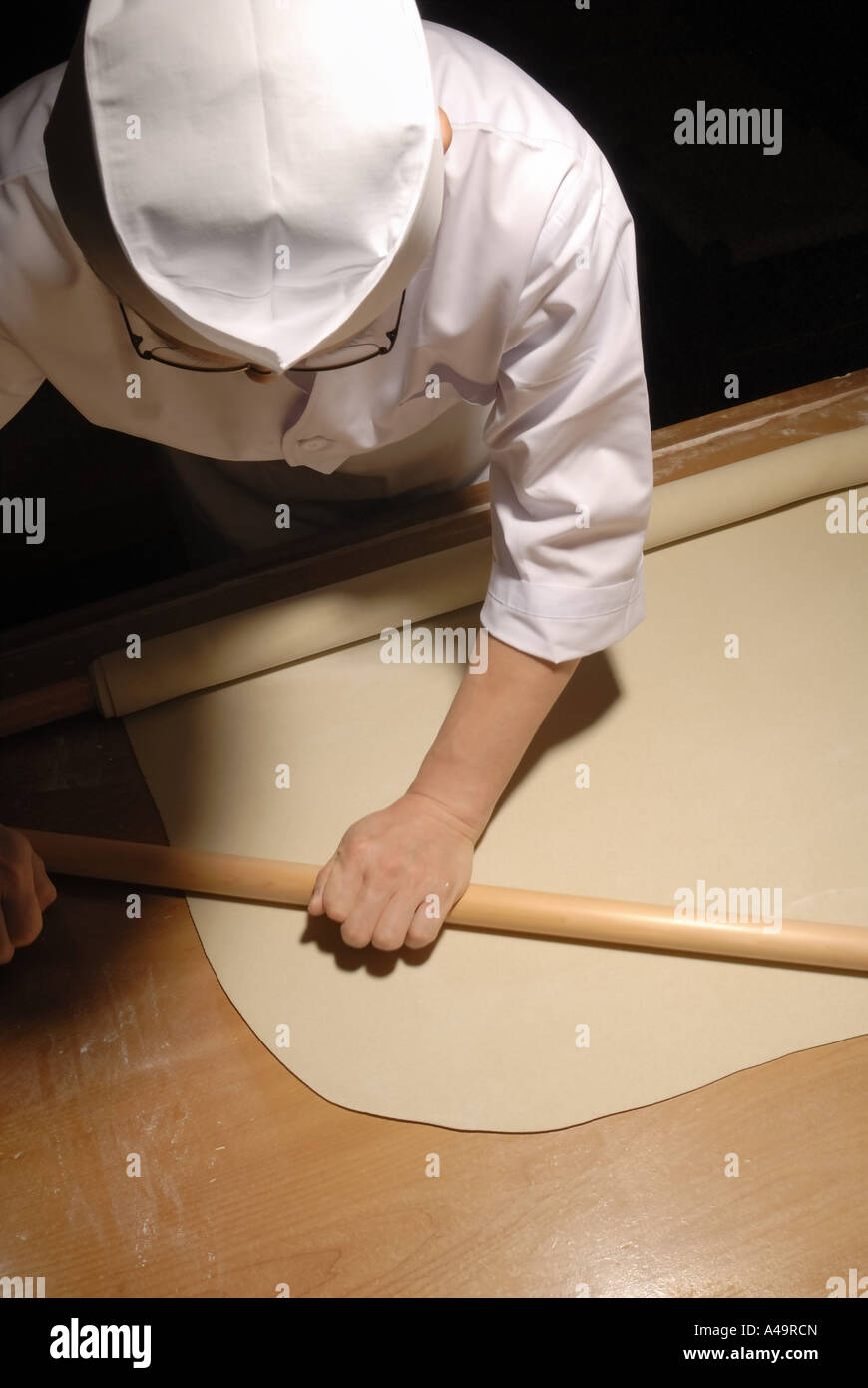 High angle view of a chef rolling dough Stock Photo