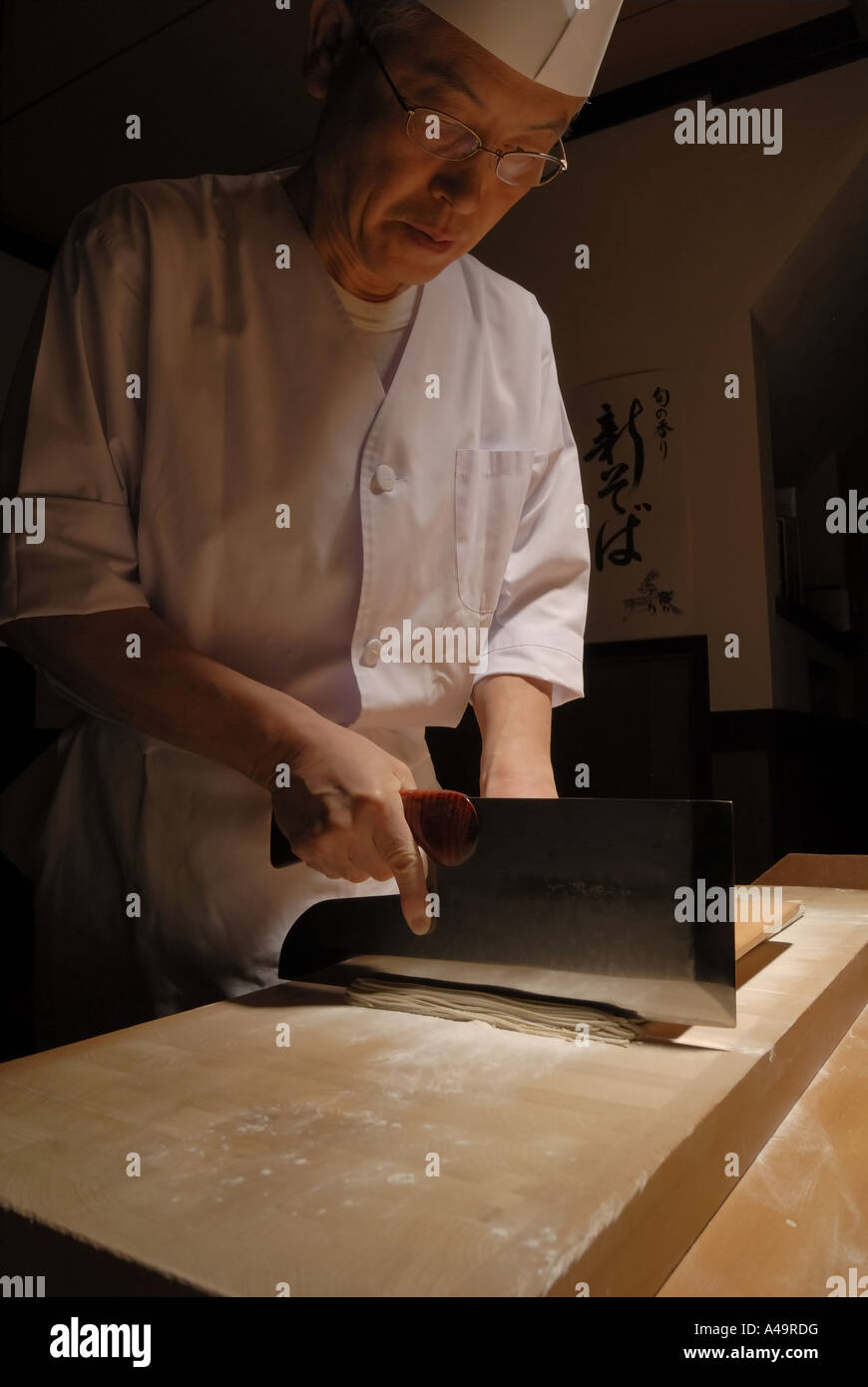 Close up of a chef cutting noodles Stock Photo
