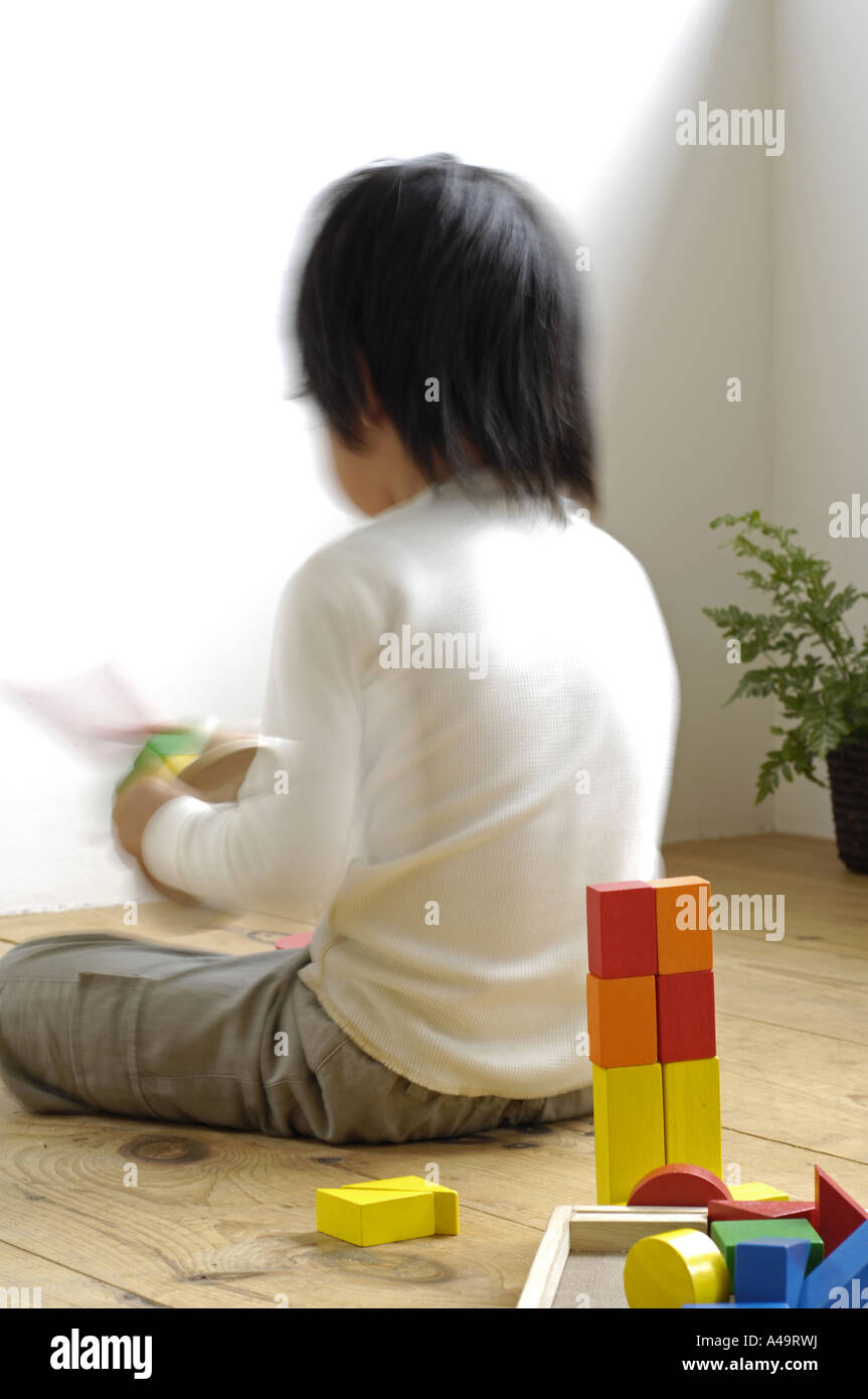 Rear view of a girl playing with toys Stock Photo - Alamy