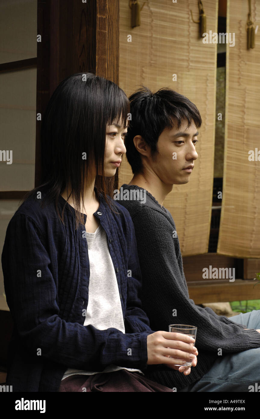 Close up of a young couple sitting Stock Photo - Alamy