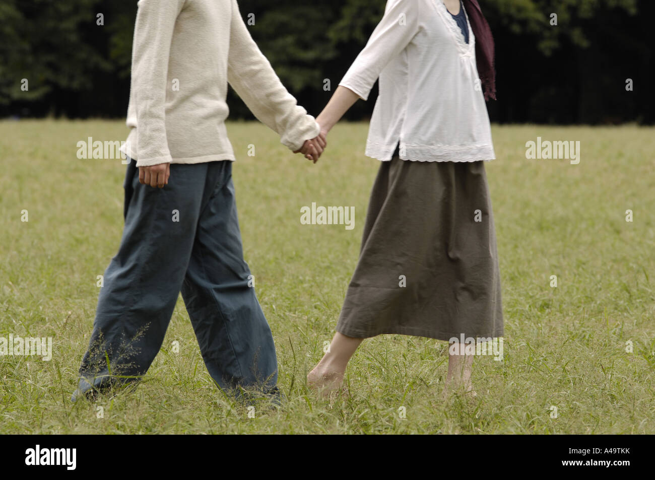 Low section view of a man holding a woman s hand Stock Photo - Alamy