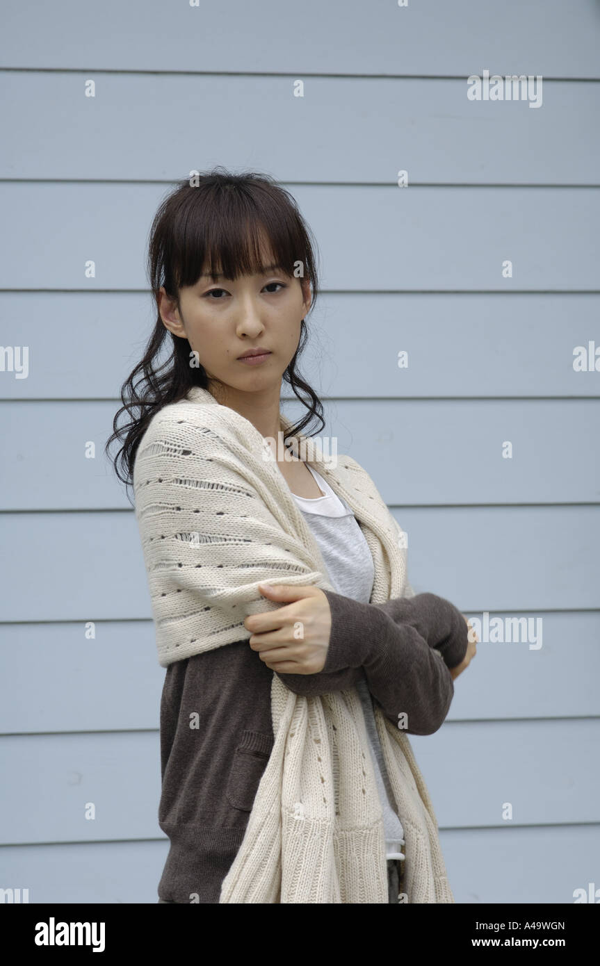Portrait of a young woman standing with her arms crossed Stock Photo ...
