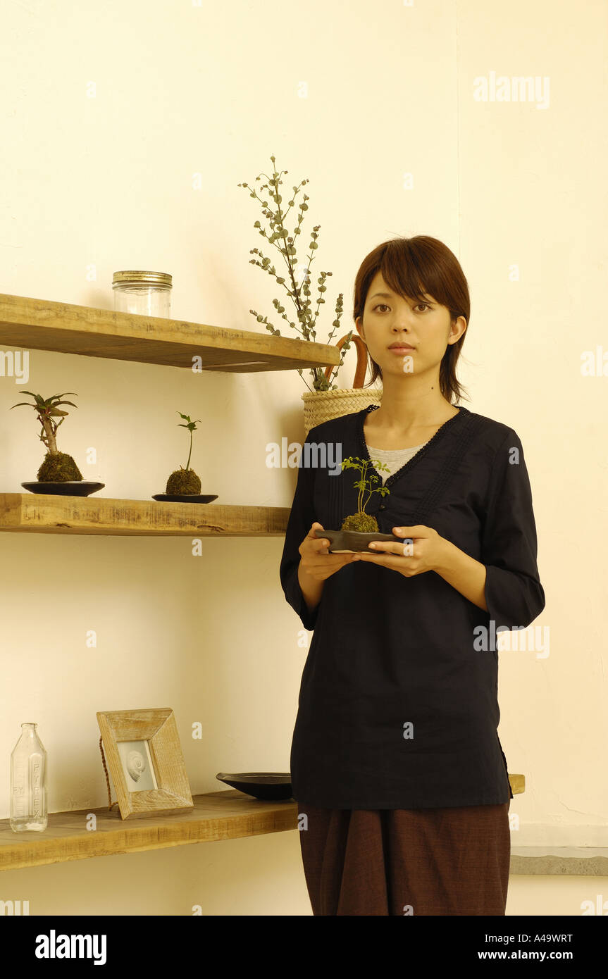 Young woman holding a potted plant Stock Photo - Alamy