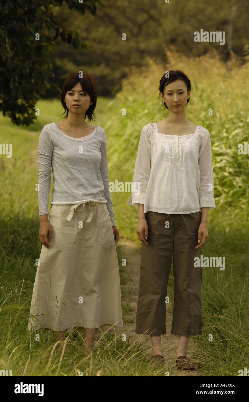 Two young women standing on a trail Stock Photo - Alamy
