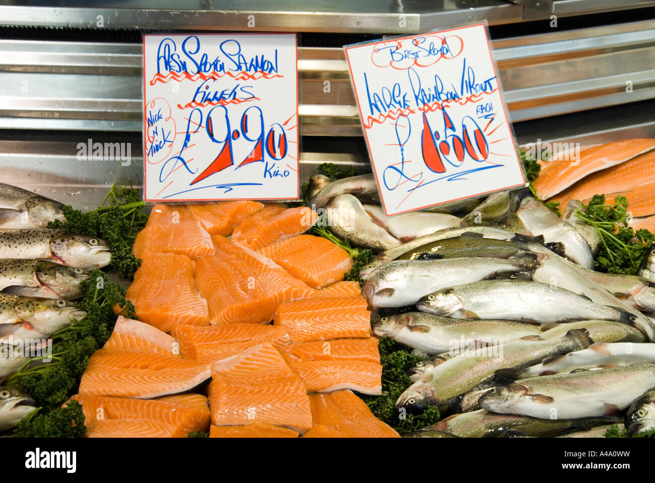 Fresh Salmon fillets and large Rainbow trouts in a fridge in Bury market Manchester UK Stock Photo