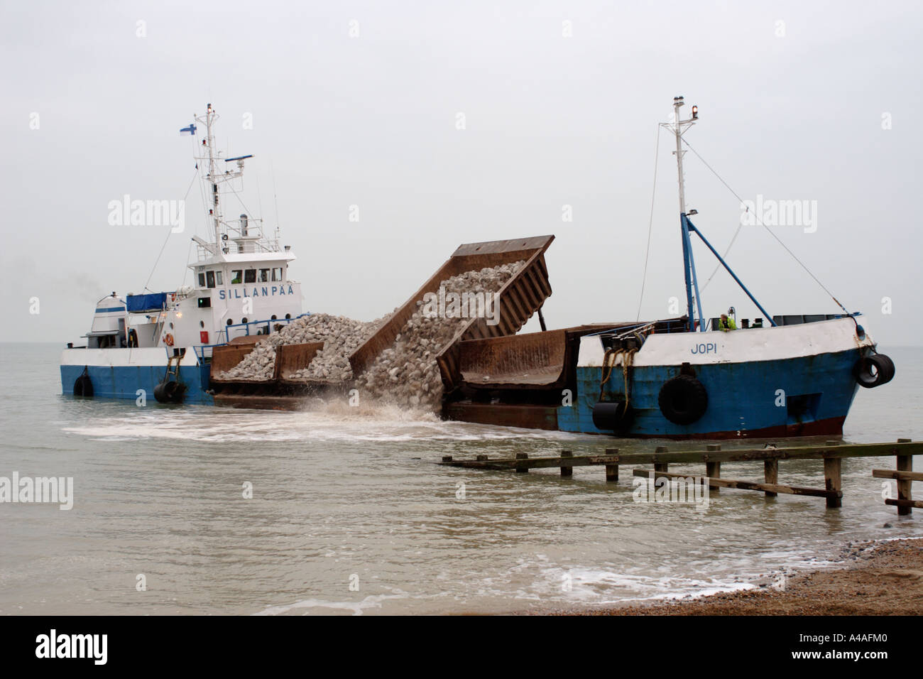 Finnish ore carrier dumping French rocks on Pevensey beach Stock Photo ...