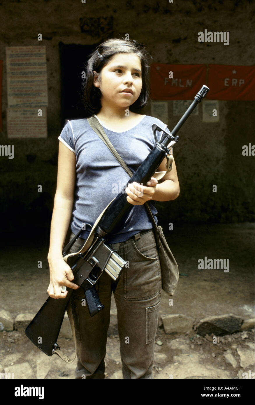 CHALATENANGO,   EL SALVADOR, FEB 1984: - Within the FPL Guerrilla's Zones of Control - A young girl holds an M16 rifle. Stock Photo