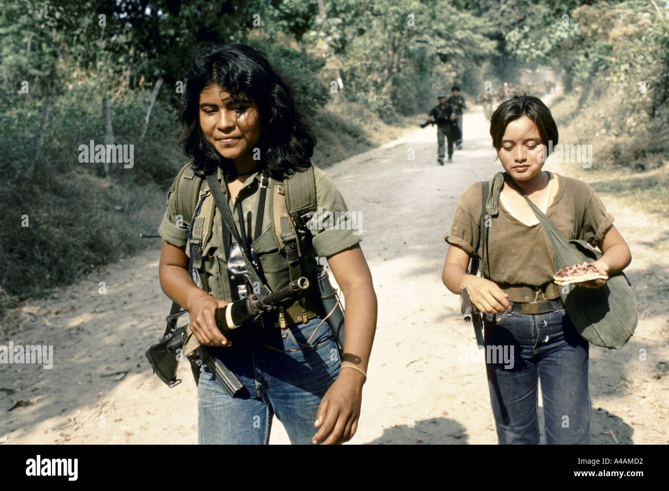 TENANCINGO,  EL SALVADOR, MARCH 1984: young women FPL rebel fighters eat a tortilla as leave town to join an FMLN offensive. Stock Photo