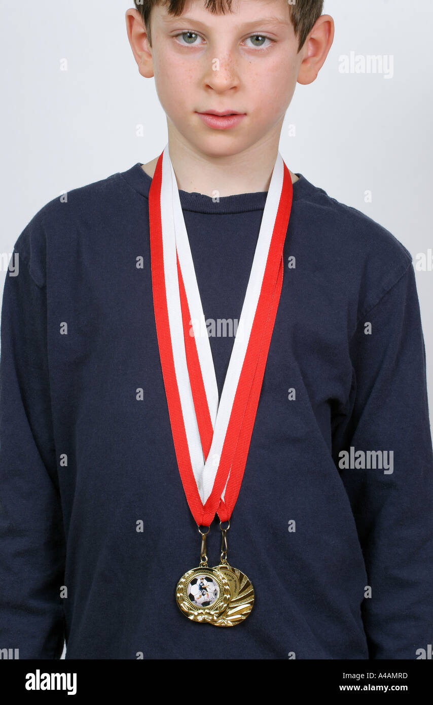 An eight year old boy with his football medals, February 2006. Stock Photo