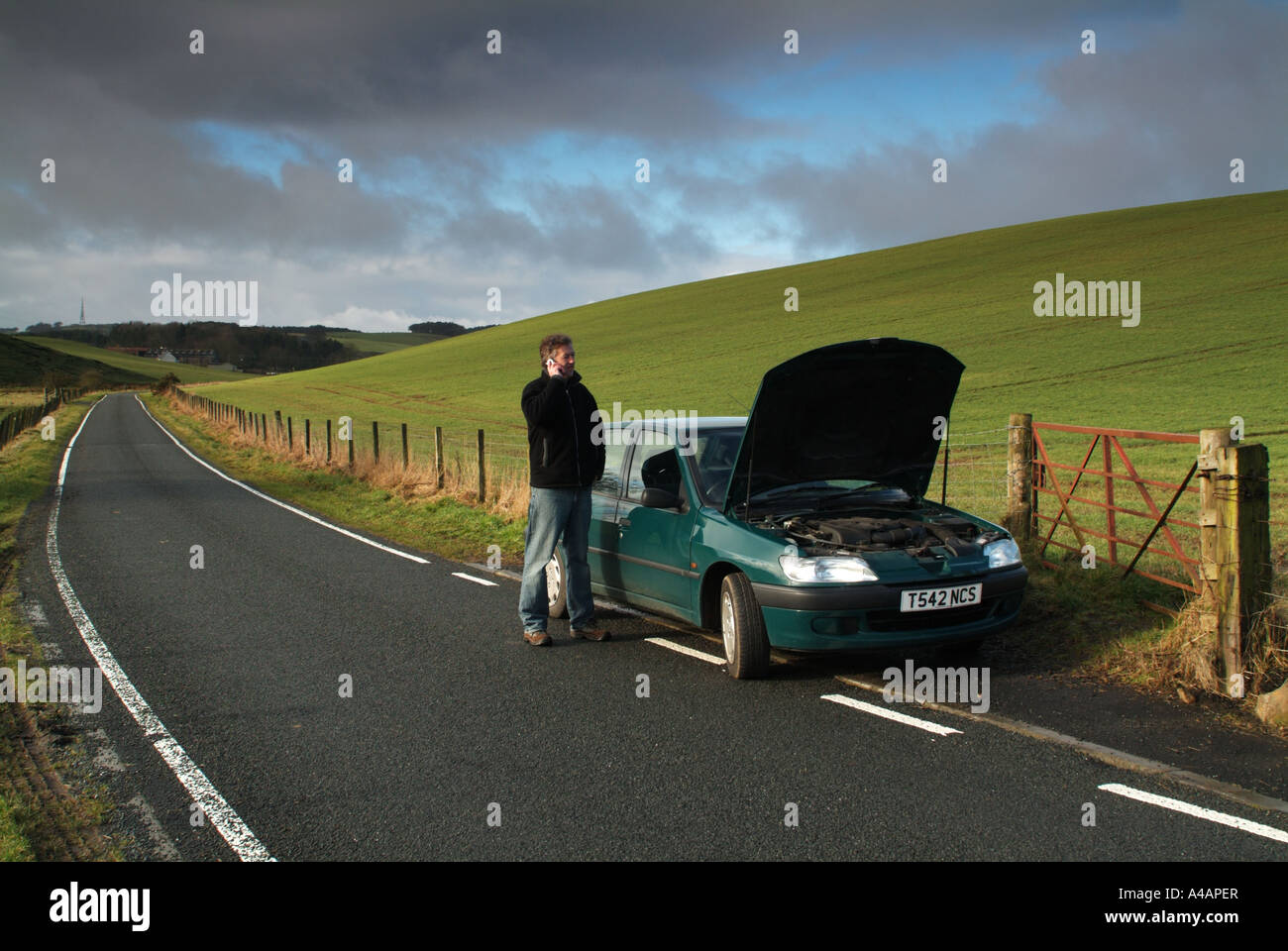 Car breakdown by the side of a remote country road, Scotland. Stock Photo