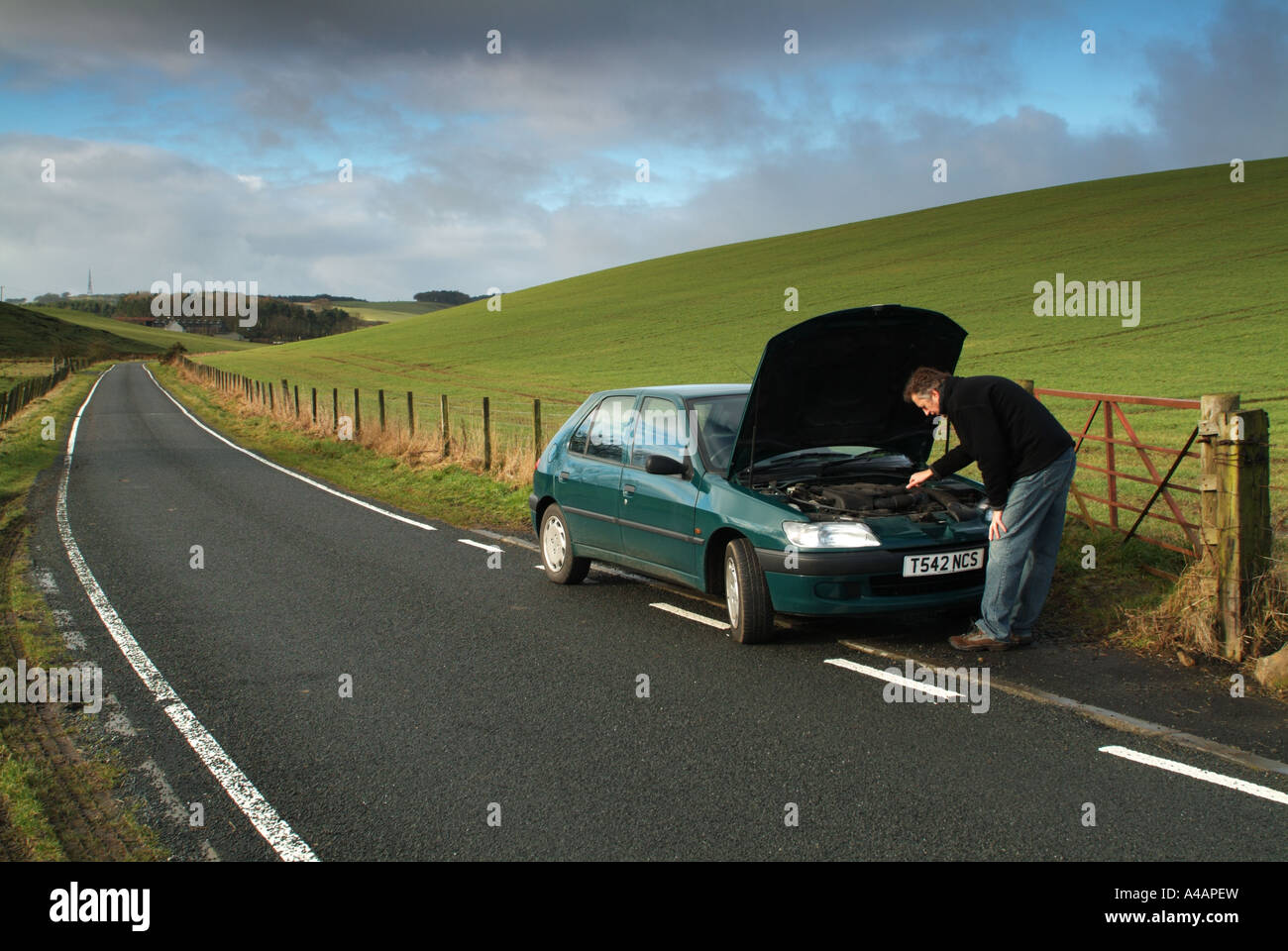 Car breakdown by the side of a remote country road, Scotland. Stock Photo