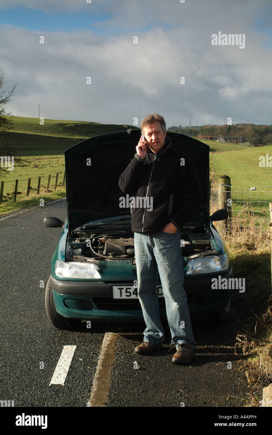 Car breakdown by the side of a remote country road, Scotland. Stock Photo